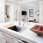 Modern kitchen featuring the Jerry stainless steel kitchen sink faucet with a high-arc spring spout, installed on a marble island countertop.